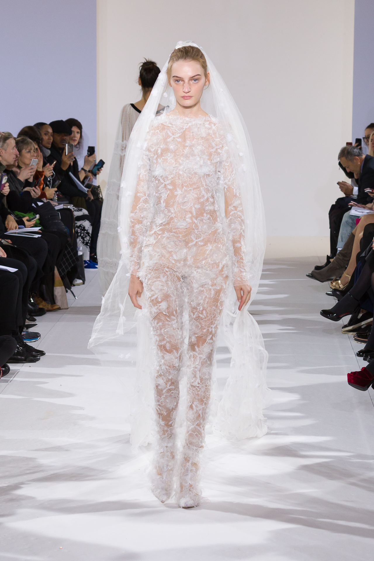 Model in a white couture runway look