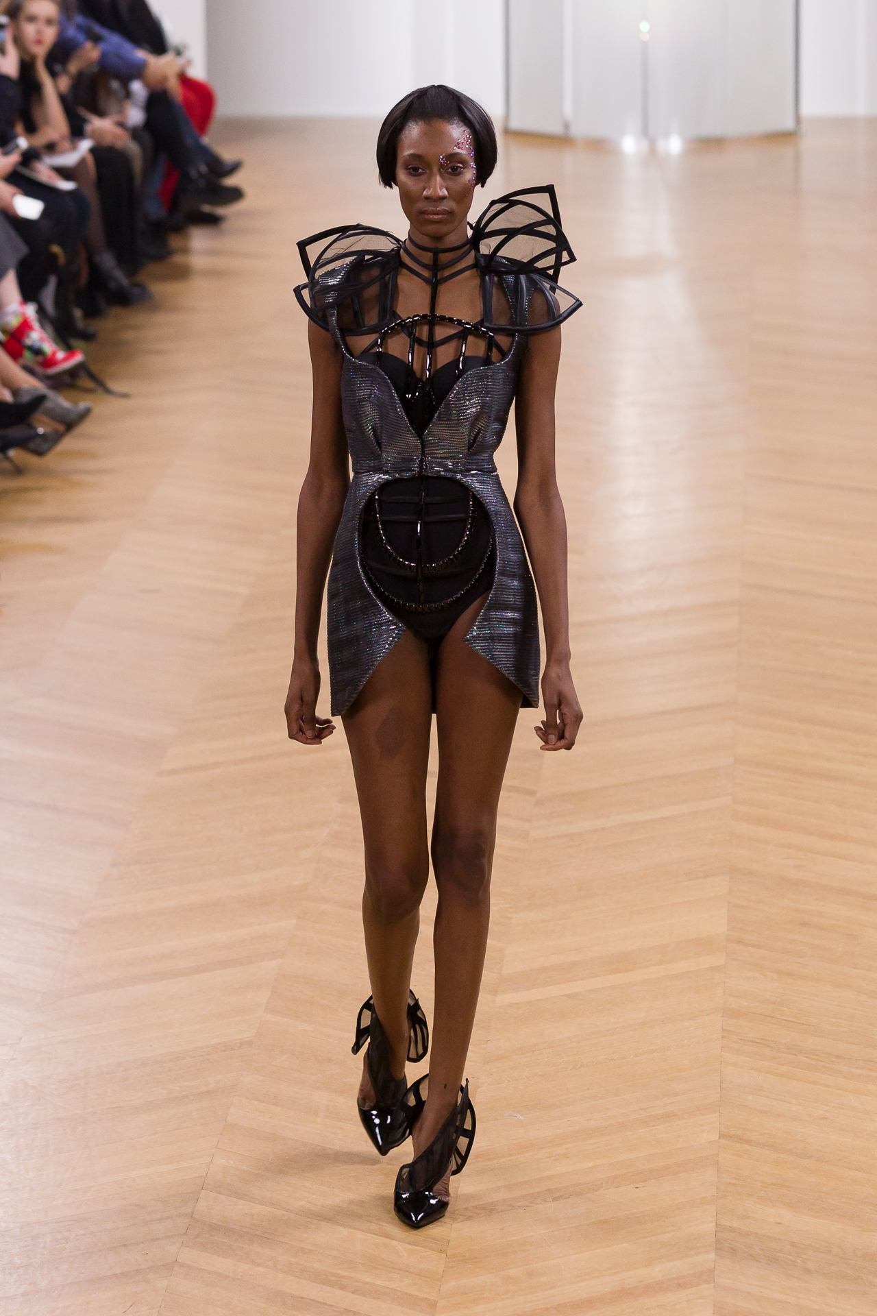 Model in a sculptural black runway look