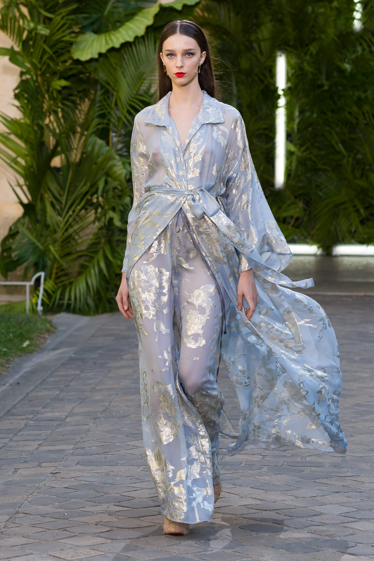 Model in a pale blue metallic runway look